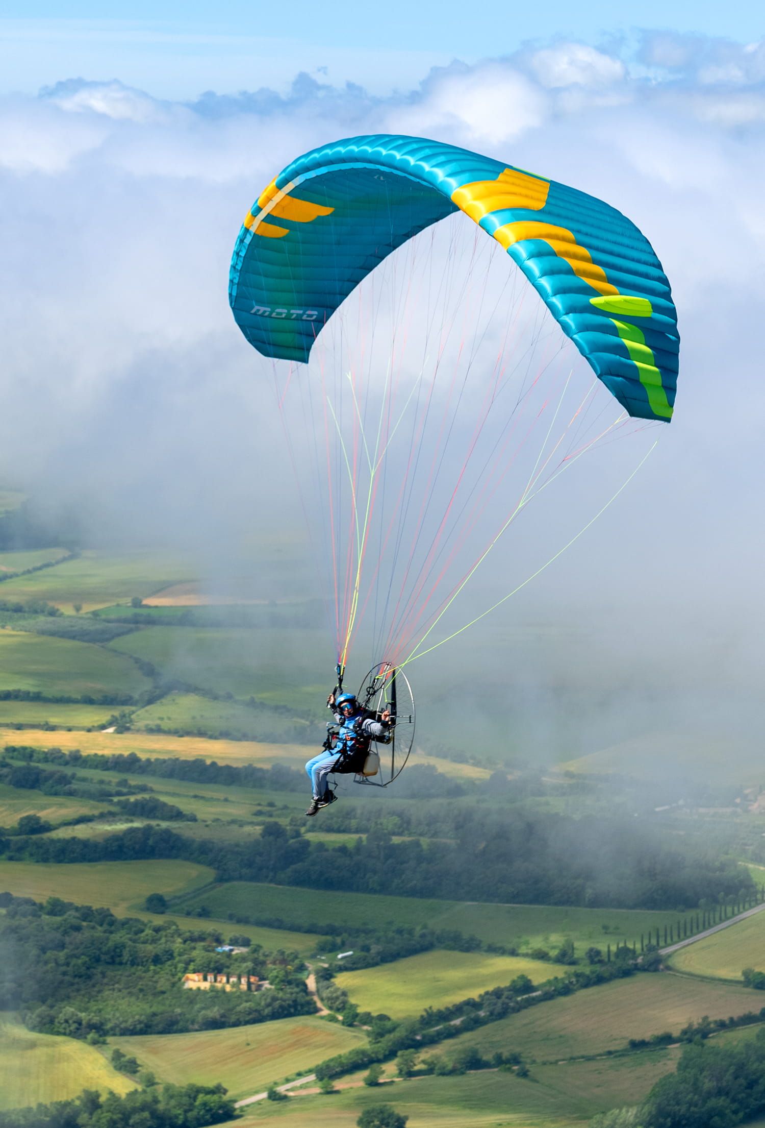 Ozone Moto paramotor wing in flight, pilot under power